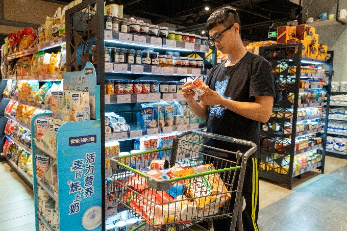 A person standing in a grocery storeDescription automatically generated with low confidence
