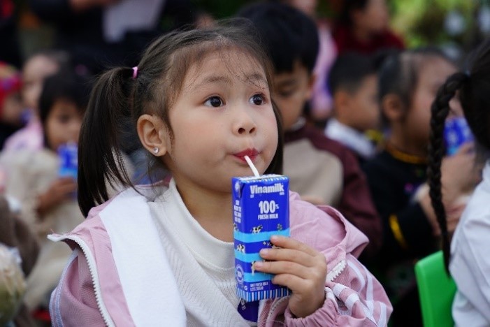 A young child drinking from a carton of juice

Description automatically generated