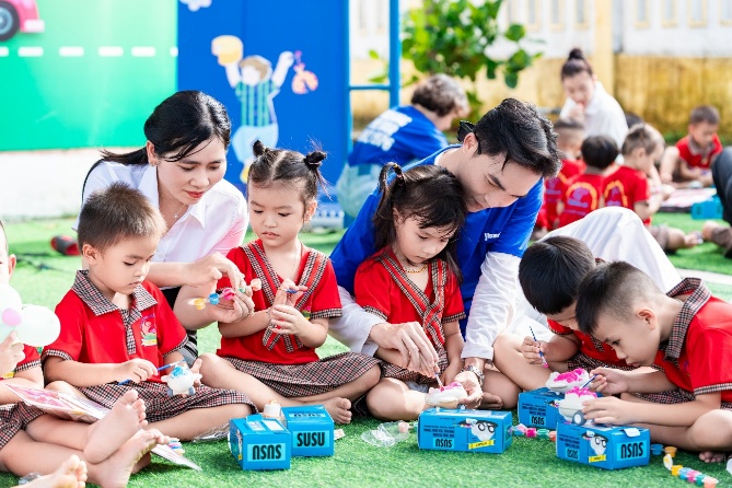 A group of people sitting on the ground with a group of children

AI-generated content may be incorrect.