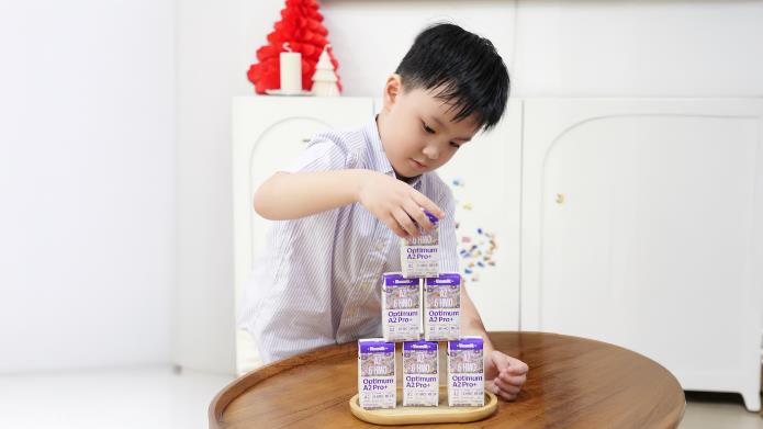 A child playing with milk cartons

AI-generated content may be incorrect.