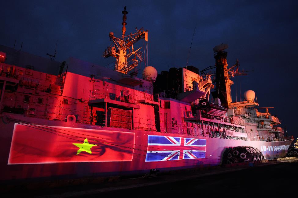 A large ship with a flag on it

AI-generated content may be incorrect.