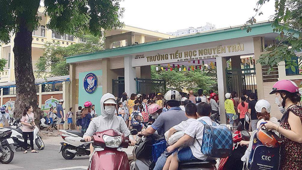 A group of people on scooters in front of a building

Description automatically generated