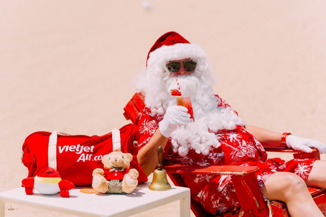 A person in a santa garment drinking a drinkDescription automatically generated