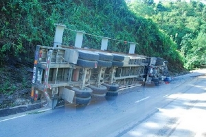 Xe tải lật ngang đè vào xe máy, 3 người bị thương nặng