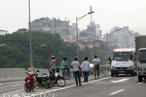 Xe ôm tranh khách, dân nhộn nhịp đi bộ ở đường cao tốc trên cao