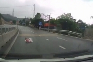 Thót tim trước cảnh em bé bò ngang qua quốc lộ khi các ô tô đang lao nhanh về phía trước