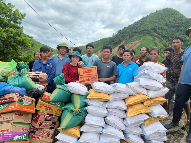 B&agrave; Vi Thị Quy&ecirc;n, B&iacute; thư Đảng ủy x&atilde; Mường T&iacute;p (Nghệ An), trực tiếp trao qu&agrave; hỗ trợ người d&acirc;n bản Na Meuang, huyện Nonghet, tỉnh Xiengkhuang (L&agrave;o) bị ảnh hưởng bởi mưa lũ.